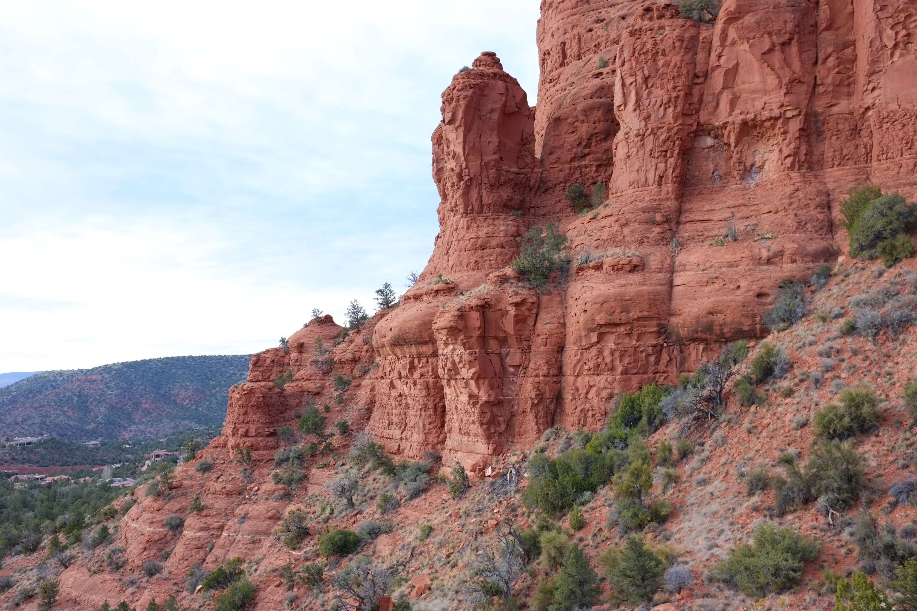 Red rock formations in Sedona, Arizona, showcasing unique geological structures and vegetation.